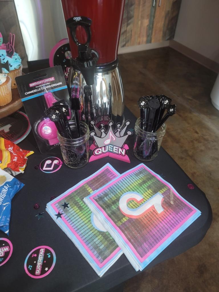 A table with cups, spoons and other items on it.