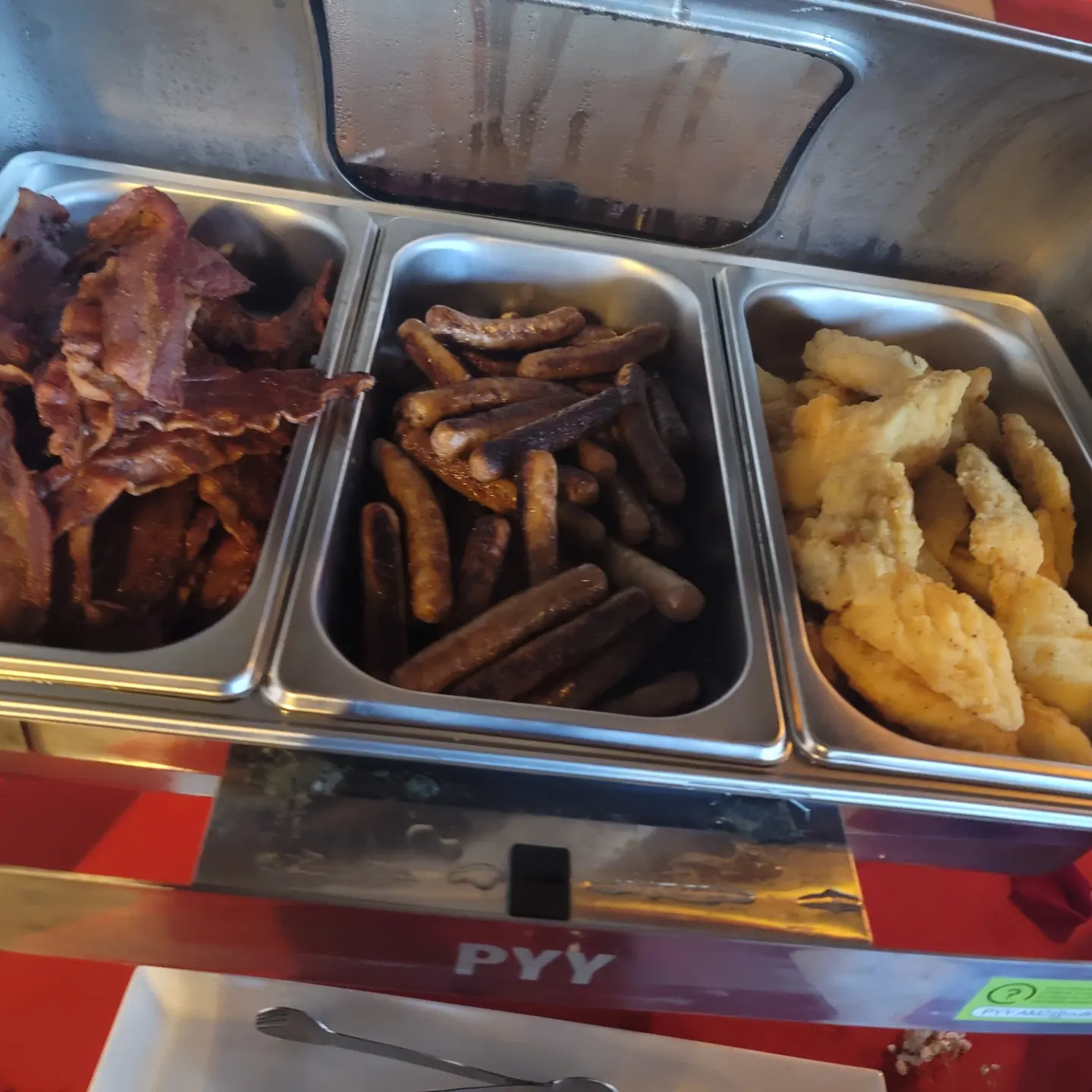 A tray of food is shown with bacon, fries and potatoes.