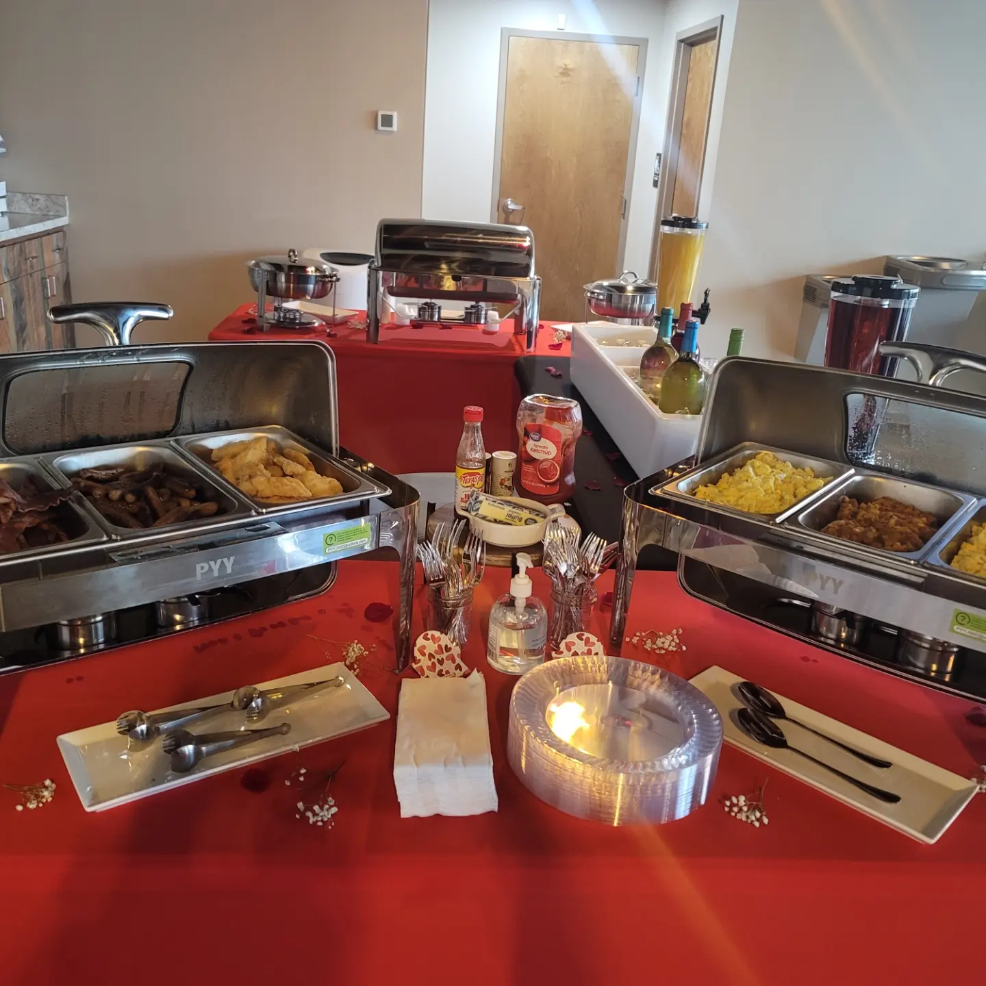 A red table with several different types of food on it.