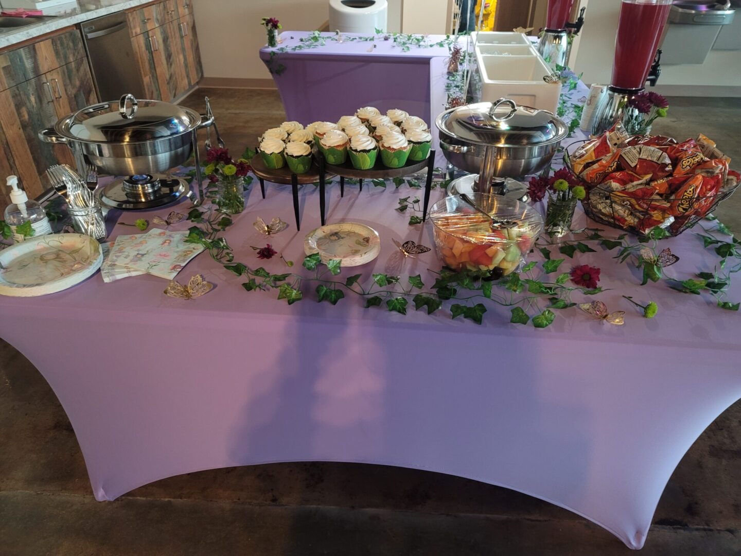 A table with cupcakes and other food on it.