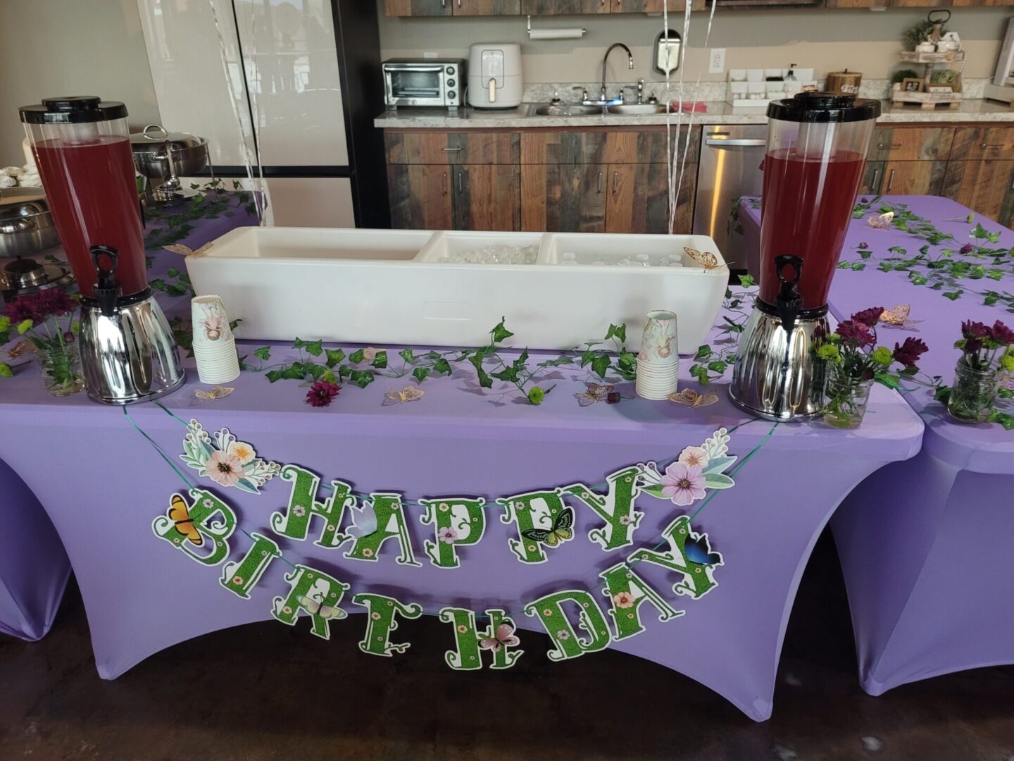 A table with purple cloth and drinks on it