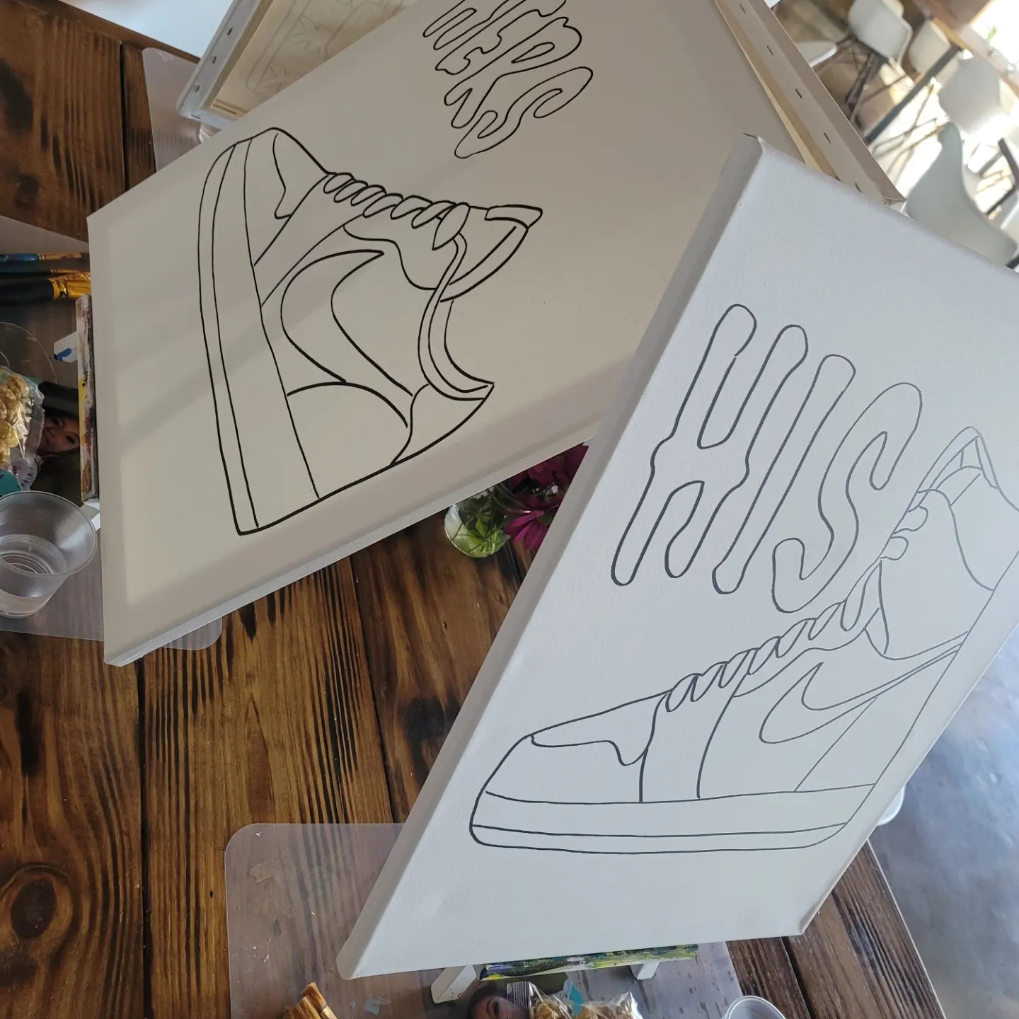 A pair of shoes are drawn on paper.