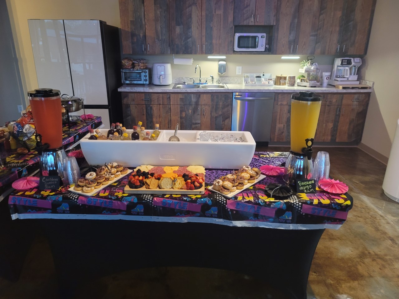 A buffet table with food on it in the kitchen.