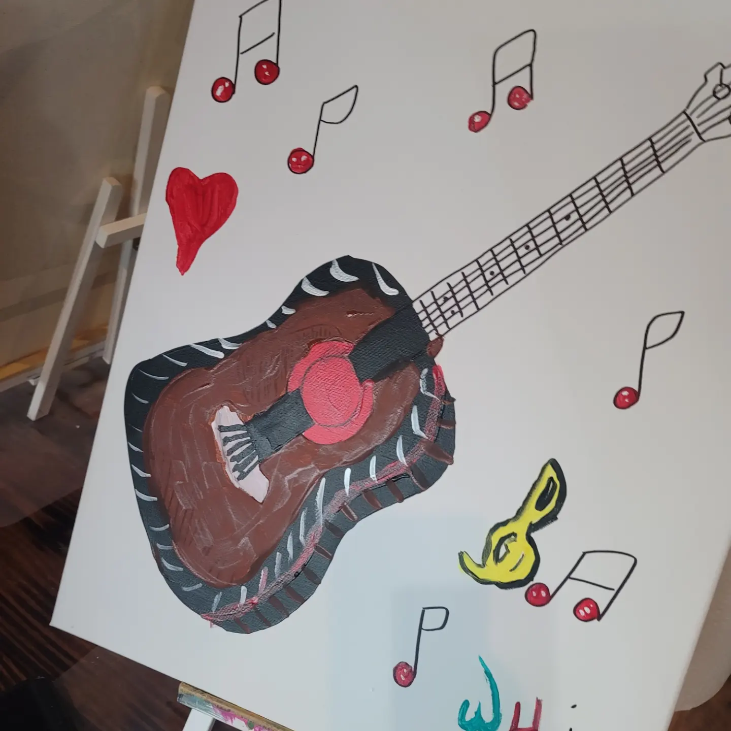 A guitar is painted on the canvas.